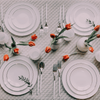 Image of a winter tablescape with elegant dinnerware.
